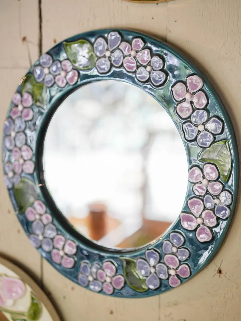 Round mid-century modern mirror w/ blue & purple flowers - Mithe Espelt (1924-2021) - 13"